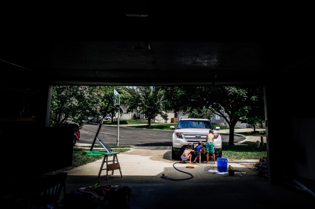 children washing car driveway summer kansas city ford explorer water soap hose