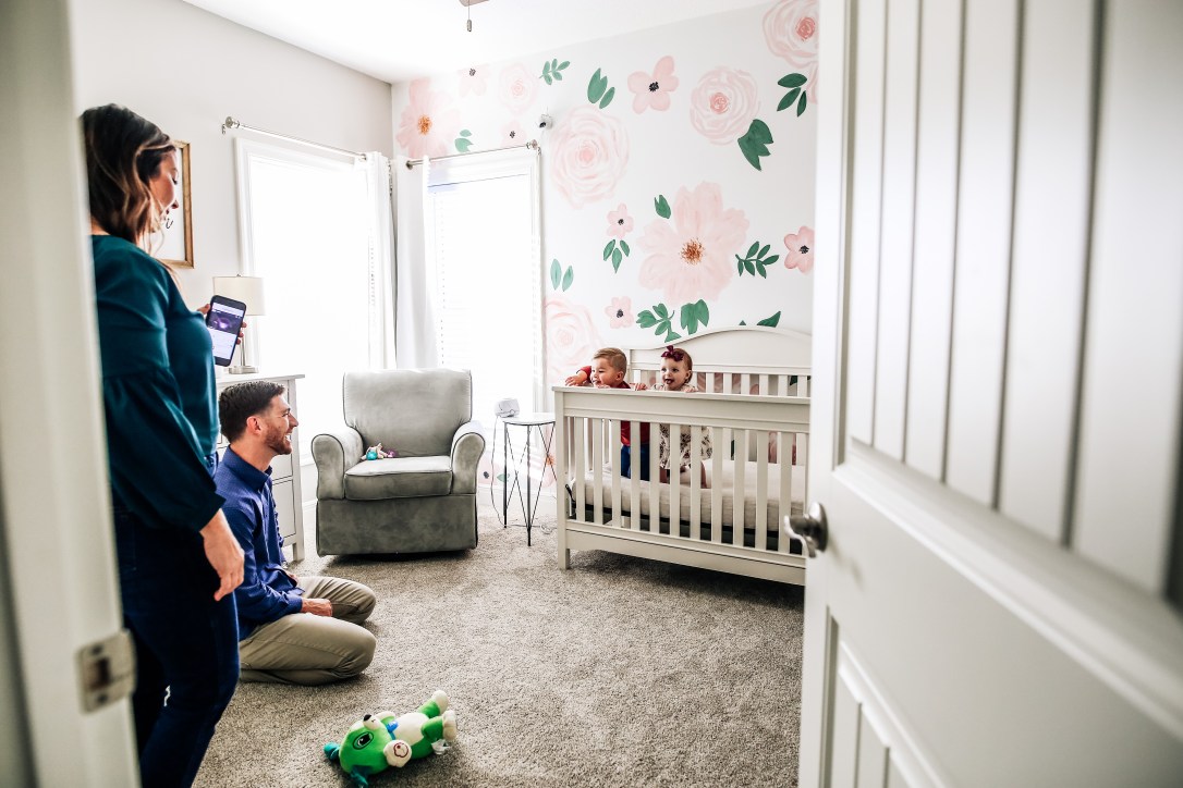 family photography laughter one year session at home crib nursery